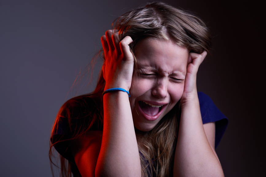 Portrait of unhappy screaming teen girl